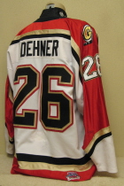 Jeremy Dehner 04-05 Green Bay Gamblers White #26. This one was worn during the 2004-05, season. Tie-down front, "G" alternate logos on the shoulder, USHL and Gemini patches on right chest. League 25 Year Anniversary patch on rear hem. Made by Gemini, this size 56 has great wear.