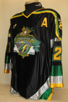 Chris Olsgard #21 99-00 Anniversary Jersey.  One of the Musketeer 20 year anniversary jerseys. Worn by Chris Olsgard during the special New Year's Eve "Black Out" Night. Has shoulder patches, NOB, USHL chest crest and alternate's "A". Made by K1 it is a size XXL.