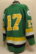Worn for two seasons by TJ Tanberg.  This #17 Green jersey has shoulder patches on both sides.   Size XXL.  NNOB   The "Puck man" starts to creep into the Musketeer theme. Due to un-popular demand, it does not show up again till 94-95, however, it will show then with vengeance!!!