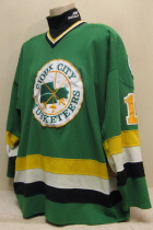 Worn for two seasons by TJ Tanberg.  This #17 Green jersey has shoulder patches on both sides.   Size XXL.  NNOB   The "Puck man" starts to creep into the Musketeer theme. Due to un-popular demand, it does not show up again till 94-95, however, it will show then with vengeance!!!