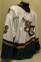 John Zeiler #12 White 2001-02. Clark Cup Championship season.  Worn by second year grinder John Zeiler. This season saw the jerseys go to a "Dazzel" type material. They proved less that durable and were replaced the following season by the traditional material. Front tie, shoulder patches, USHL crest and AMC memorial patch added half way through the season. This one has the greatest wear ever!!! One of my favs!!!. Made by OT Sports