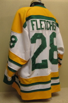 Justin Fletcher #28 2002-03 Throwback Jersey  This special throwback jersey (see first season jersey #30) was worn by Justin Fletcher. This commerated 30 years of Musketeer hockey. Used as an alternate, they were raffled of near the end of the season. It is a size 48, made by Gemini. 