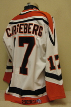 Omaha Lancers Mats Carsberg 1996-97 This gamer was worn by Mats Carsseberg uring the 96-97 season. "D" on right chest is a memorial for lost host parent. CCM logo and round USHL logo on rear hem, NOB. Shows great wear. Made by Bauer, size 52.  