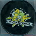 This logo puck style was used for all Musketeer games from around 1997 through the 2003-04 season. Even though SCM had a major logo change in 2000, three seasons worth of ordered game pucks arrived with the old logo (StarBurst/Puckman) instead of the new SC logo. The new-old logo pucks were not returned or replaced. Two versions versious exisist, pre 2000 the USHL logo on back with the Leaf and the newer USHL logo with the star. Season 03-04 saw use of both Puck Man and the new "M" logo.