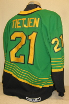 Nick Tietjen Away #21 1996-97  This one was worn during the 96-97 season by Nick Tietjen. NOB and yellow on black USHL chest patch. This away sweater is made by CCM and is a size 52.