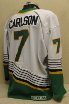 Jeff Carlson white #7 1996-97  This one was worn during the 96-97 season by Nick Tietjen. NOB and yellow on black USHL chest patch. This away sweater is made by CCM and is a size 52.